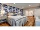 Bright bedroom with decorative wallpaper and wood-look flooring at 36750 Us 19 N # 24-213, Palm Harbor, FL 34684