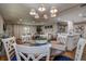 Bright dining area open to the living room features a modern chandelier, and seating for six at 36750 Us 19 N # 24-213, Palm Harbor, FL 34684
