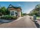 Gated community entrance with manicured landscaping and secure access point at 36750 Us 19 N # 24-213, Palm Harbor, FL 34684