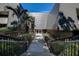 Striking contemporary building exterior with lush landscaping and palm trees at 36750 Us 19 N # 24-213, Palm Harbor, FL 34684