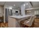 Modern kitchen island with quartz countertops and stainless steel appliances and seating at 36750 Us 19 N # 24-213, Palm Harbor, FL 34684