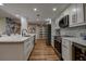 Bright, renovated kitchen with stainless appliances, white cabinets, and island at 36750 Us 19 N # 24-213, Palm Harbor, FL 34684