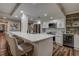 Spacious kitchen island with modern appliances, seating, and wine cooler at 36750 Us 19 N # 24-213, Palm Harbor, FL 34684