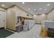 Bright laundry room with multiple white washing machines and tiled flooring at 36750 Us 19 N # 24-213, Palm Harbor, FL 34684