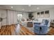 Well-lit living room with floor-to-ceiling curtains, wood flooring, and comfortable seating arrangements at 36750 Us 19 N # 24-213, Palm Harbor, FL 34684