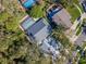 Aerial view showcasing a lovely house, swimming pools, green landscaping, and neighborhood at 4202 Deepwater Ln, Tampa, FL 33615