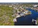 This aerial shows the canal-front home with dock featuring nicely manicured landscaping and neighborhood at 4202 Deepwater Ln, Tampa, FL 33615