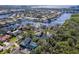 A high-angle view shows the home with a screened-in pool, landscaping, and the surrounding neighborhood at 4202 Deepwater Ln, Tampa, FL 33615