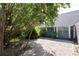 Gravel backyard featuring a house with blue sidings and white trim at 4202 Deepwater Ln, Tampa, FL 33615