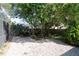 Private backyard featuring lush landscaping and a rock garden at 4202 Deepwater Ln, Tampa, FL 33615