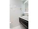 Modern powder room with floating vanity, unique lighting fixtures, and stylish decorative wall art at 4202 Deepwater Ln, Tampa, FL 33615
