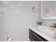 Bathroom vanity with countertop sink, brushed gold faucet, flower decorations, and a lighted mirror at 4202 Deepwater Ln, Tampa, FL 33615