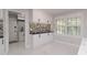 Bright dining area featuring white cabinets, black hardware, mosaic backsplash, and natural light from shuttered windows at 4202 Deepwater Ln, Tampa, FL 33615