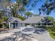 Charming blue house with a large driveway and a beautiful landscape at 4202 Deepwater Ln, Tampa, FL 33615