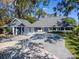 Charming home featuring a spacious driveway, lush landscaping, and inviting front porch at 4202 Deepwater Ln, Tampa, FL 33615