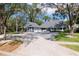 Charming two-story home with mature trees, a long driveway and beautiful landscaping at 4202 Deepwater Ln, Tampa, FL 33615
