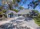 Large single story home with three-car garage, manicured landscaping and gray roof at 4202 Deepwater Ln, Tampa, FL 33615