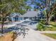 Charming home featuring a spacious driveway, lush landscaping, and inviting front porch at 4202 Deepwater Ln, Tampa, FL 33615