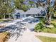 Charming home featuring a spacious driveway, lush landscaping, and inviting front porch at 4202 Deepwater Ln, Tampa, FL 33615