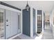 Inviting front porch with a modern lantern, paneled siding and painted trim at 4202 Deepwater Ln, Tampa, FL 33615