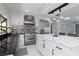 Modern kitchen with stainless steel appliances, stylish lighting, and island seating at 4202 Deepwater Ln, Tampa, FL 33615