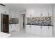 Spacious kitchen with modern cabinets, under cabinet lighting and beautiful tile backsplash at 4202 Deepwater Ln, Tampa, FL 33615