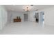 Open-concept living room with a stylish bar area, fireplace, chandelier, and elegant tile floors at 4202 Deepwater Ln, Tampa, FL 33615