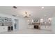 Spacious living room features a bar area, custom cabinets, a fireplace, and seamless white tile flooring at 4202 Deepwater Ln, Tampa, FL 33615