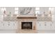 Elegant living room with brick fireplace, custom cabinetry, and stylish decor creating a cozy ambiance at 4202 Deepwater Ln, Tampa, FL 33615