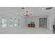 Bright living room with French doors, chandelier, and stylish bar area with custom cabinets and tile floors at 4202 Deepwater Ln, Tampa, FL 33615