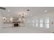 Spacious living room featuring fireplace, custom cabinetry, recessed lighting, and french doors with plantation shutters at 4202 Deepwater Ln, Tampa, FL 33615
