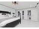 Serene main bedroom with a black king-size bed, closet, and stylish lighting creating a relaxing retreat at 4202 Deepwater Ln, Tampa, FL 33615