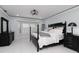 Inviting main bedroom showcasing a black four-poster bed, bay window, and elegant decor for a relaxing atmosphere at 4202 Deepwater Ln, Tampa, FL 33615