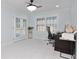 Bright office space with a ceiling fan, shuttered windows, and direct access to the outdoor living area at 4202 Deepwater Ln, Tampa, FL 33615
