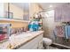 Bathroom featuring granite countertop vanity, a glass-enclosed shower, and organized storage shelves at 4527 W Minnehaha St, Tampa, FL 33614