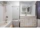 Cozy bathroom featuring a shower and tub combination with convenient vanity storage at 4527 W Minnehaha St, Tampa, FL 33614