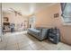 The room has a gray couch, desk, and pink gaming chair, combining relaxation and productivity at 4527 W Minnehaha St, Tampa, FL 33614