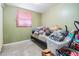 A cluttered bedroom featuring a bed, window, and various personal items, awaiting decluttering and personalization at 4527 W Minnehaha St, Tampa, FL 33614
