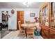Dining room with wooden table and chairs next to a china cabinet, blending functionality and classic design at 4527 W Minnehaha St, Tampa, FL 33614