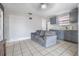 Open floor plan with an eat-in kitchen features matching gray cabinetry and abundant natural light at 4527 W Minnehaha St, Tampa, FL 33614