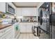 A functional kitchen featuring white cabinets, stainless steel appliances, and tiled backsplash at 4527 W Minnehaha St, Tampa, FL 33614