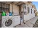 Outdoor laundry area with modern washer and dryer units, located on the side of the house at 4527 W Minnehaha St, Tampa, FL 33614