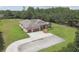 Expansive aerial view of property featuring a large lawn, mature trees and long driveway at 4608 Scott Rd, Lutz, FL 33558