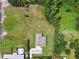 Aerial view featuring a home with horse fencing, a large backyard, and mature trees at 4608 Scott Rd, Lutz, FL 33558