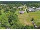 Aerial view of the property showcasing a large lot with mature trees and the surrounding neighborhood at 4608 Scott Rd, Lutz, FL 33558