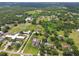 Aerial view of a sprawling neighborhood featuring mature trees, spacious lots, and horse fencing at 4608 Scott Rd, Lutz, FL 33558