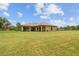 View of backyard with large grassy area at 4608 Scott Rd, Lutz, FL 33558