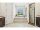 Bright bathroom with tub, shower, and neutral tiling at 4608 Scott Rd, Lutz, FL 33558