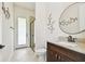 Bathroom featuring modern vanity, tile flooring, and a glass-door shower at 4608 Scott Rd, Lutz, FL 33558