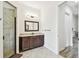Elegant bathroom featuring a tiled shower, a dark wood vanity, and neutral flooring at 4608 Scott Rd, Lutz, FL 33558